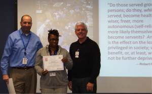 Senior Sponsor, Ed Reeve and Class Sponsor, David Bates, commending TD Partner, Shonda Lampkins with her certificate of completion for Introduction to Servant Leadership.